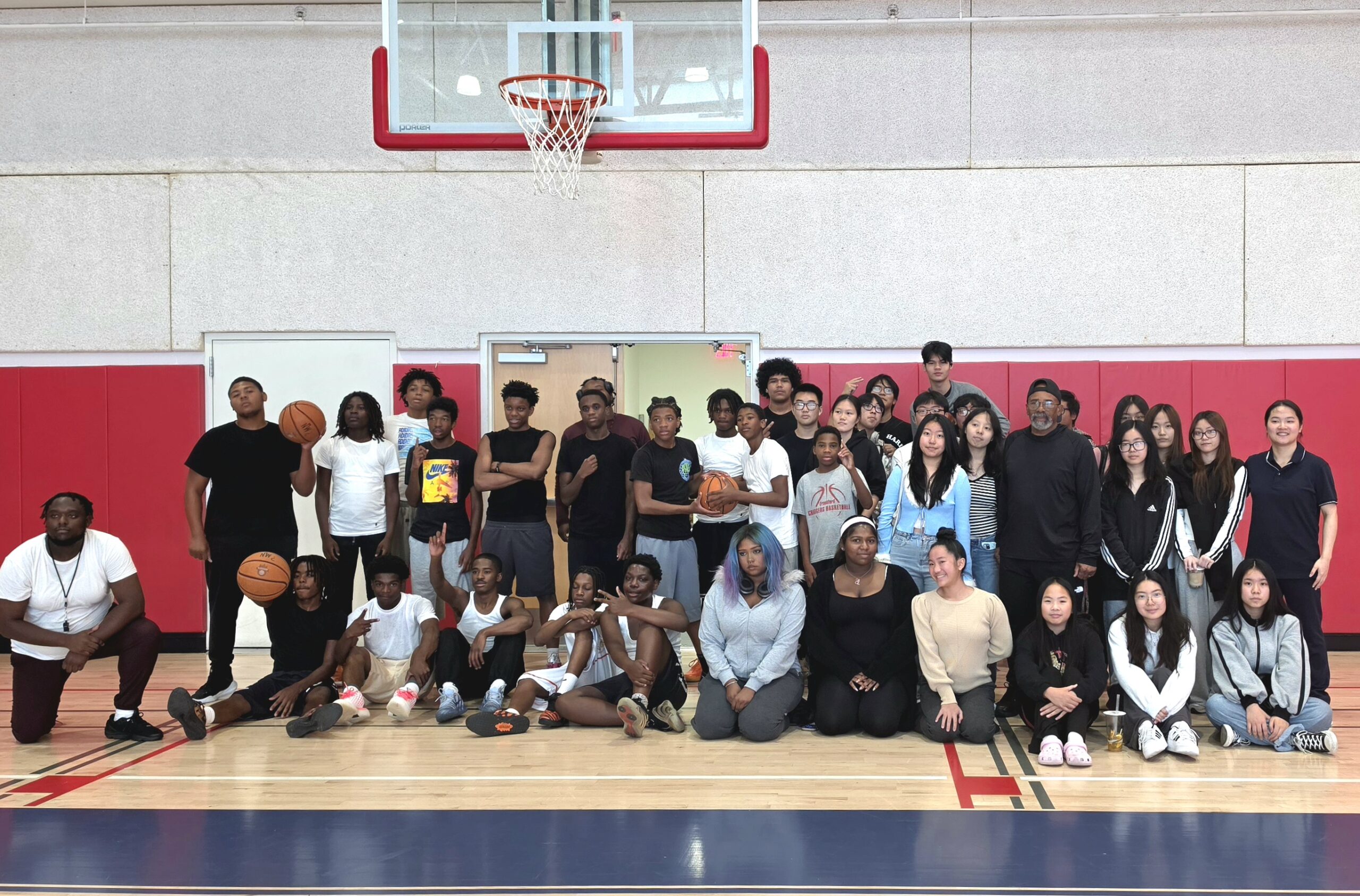 Black & Gold 2.0 participants and staff posing together on the basketball court